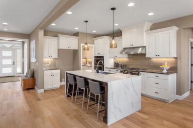 Beautiful kitchen in new luxury home with waterfall island, quar