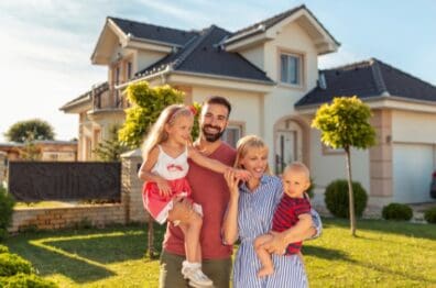 A family standing in front of their new home purchased with a Lafayette Federal mortgage.