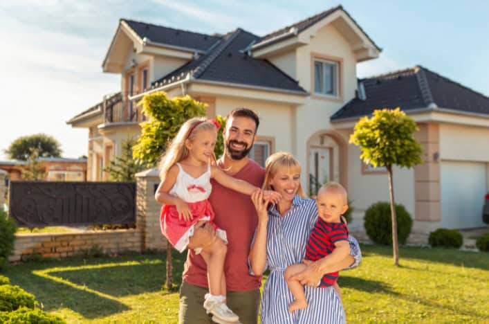 A family standing in front of their new home purchased with a Lafayette Federal mortgage.
