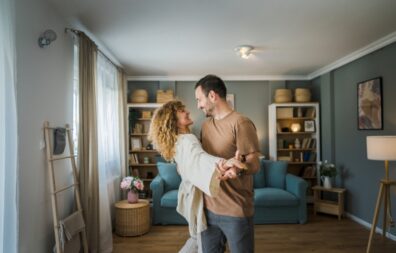 Happy couple adult Caucasian man woman husband and wife dance at home 827px x 528px (1)